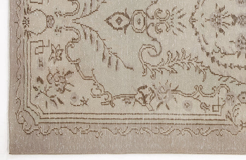 Load image 1 in gallery view. Beige and taupe distressed rug with a traditional floral medallion pattern and a decorative border.