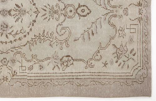 Load image 1 in gallery view. Beige and taupe vintage-style rug with a distressed floral medallion pattern and a decorative border.