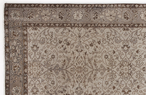 Load image 1 in gallery view. Taupe and brown traditional rug with a distressed floral medallion pattern and a detailed border.