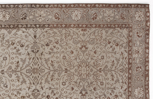 Load image 1 in gallery view. Taupe and brown traditional rug with a detailed floral medallion pattern and a decorative border.