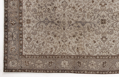 Load image 1 in gallery view. Taupe and brown traditional rug with a distressed floral vine pattern and a detailed geometric border.