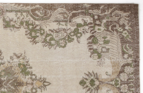 Load image 1 in gallery view. Beige rug with a distressed brown and green floral medallion pattern on a white background.