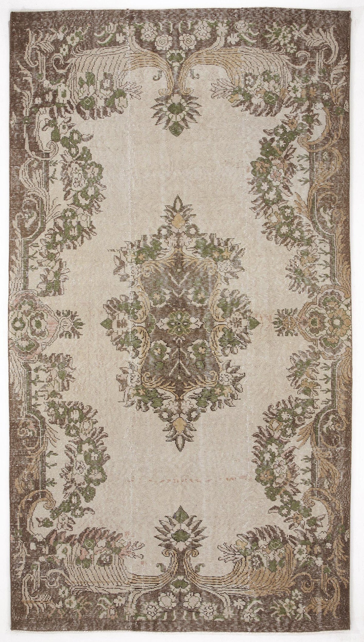 Beige, brown, and sage green vintage-style rug with a central floral medallion and ornate botanical border.