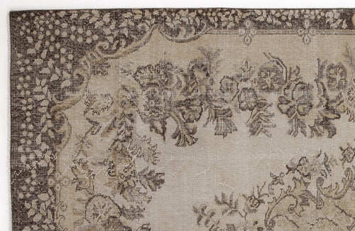 Load image 1 in gallery view. Dark brown and beige rug with a distressed floral medallion pattern and a decorative border.