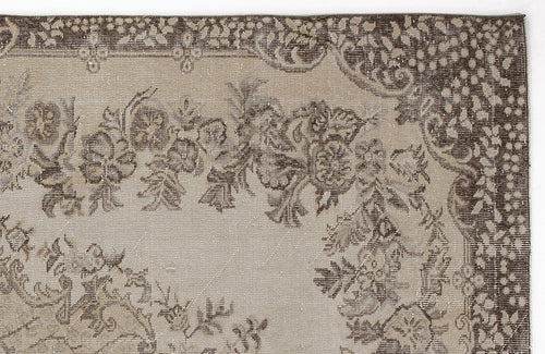 Load image 1 in gallery view. Close-up of a beige and dark brown vintage-style rug featuring a floral medallion pattern and a decorative border.