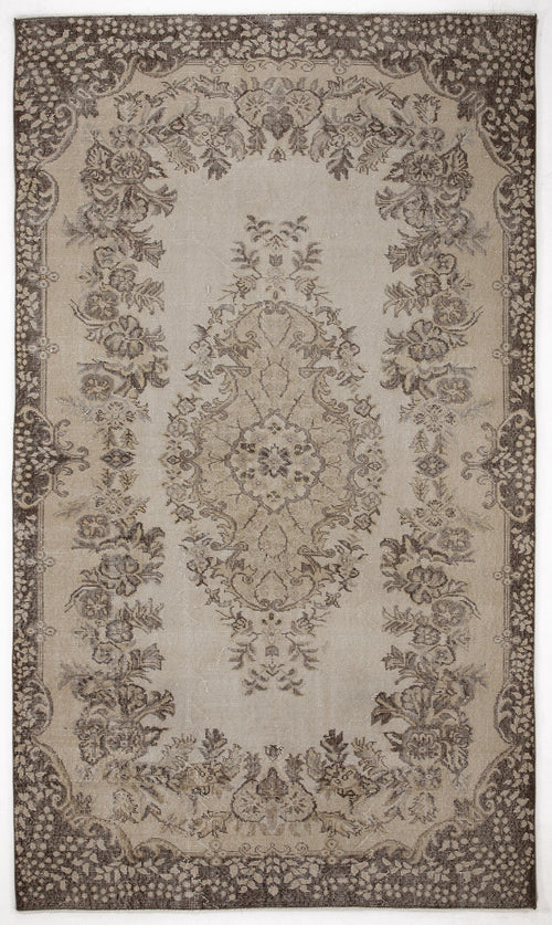 Load image 1 in gallery view. Beige and dark brown traditional rug with a central floral medallion and ornate botanical border.