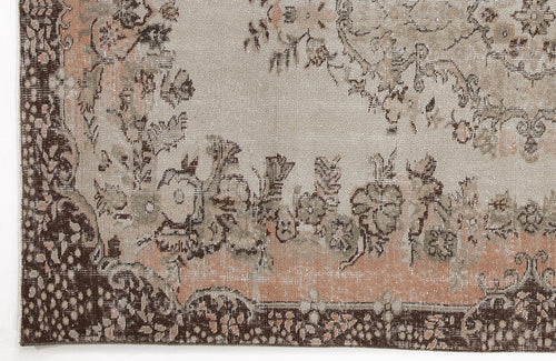 Load image 1 in gallery view. Distressed beige, brown, and muted peach rug with a traditional floral medallion pattern and ornate border.