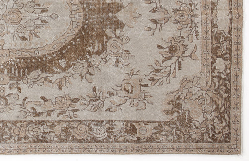 Load image 1 in gallery view. Beige and brown distressed rug with a traditional floral medallion pattern and ornate border.