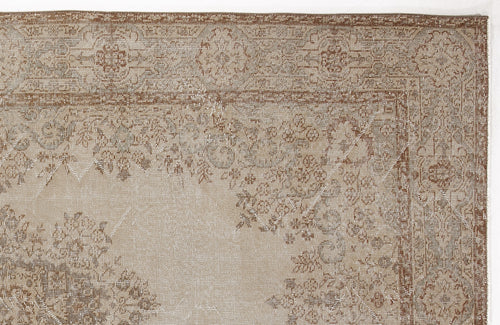 Load image 1 in gallery view. Tan and brown traditional rug with a distressed floral medallion pattern and a detailed border.