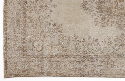Load image 1 in gallery view. Beige and taupe distressed rug with a faded traditional floral medallion pattern and a decorative border.