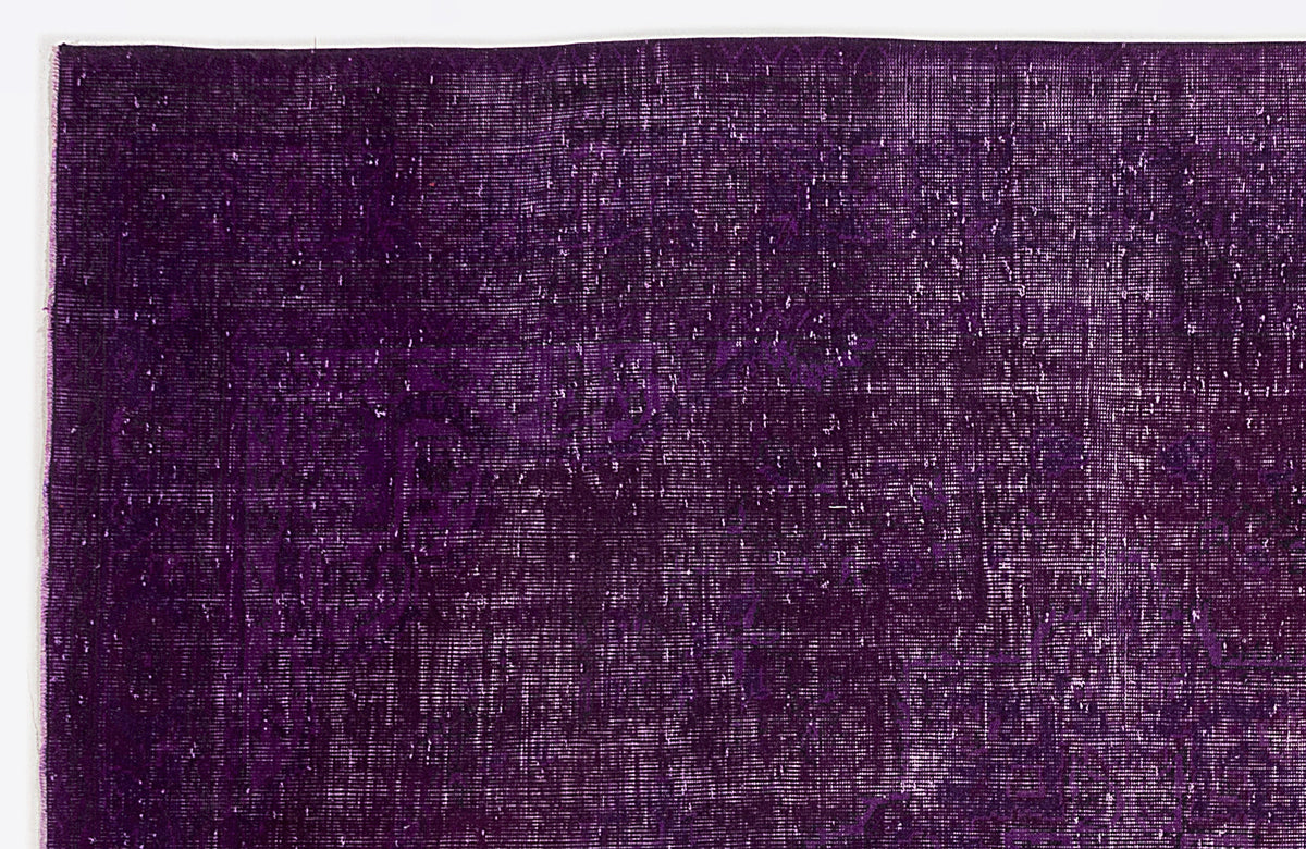 Deep purple vintage-style rug with a distressed, faded traditional medallion pattern.