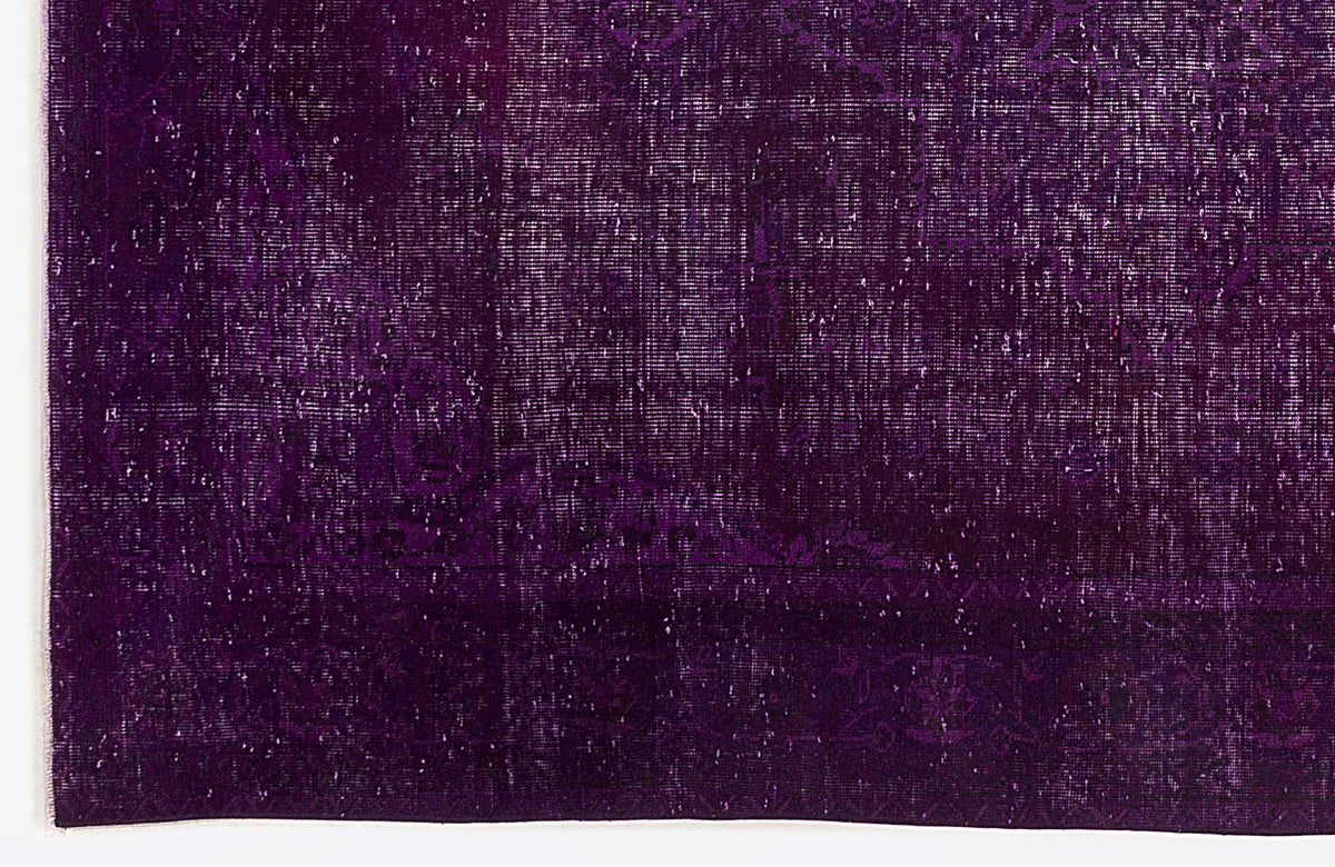 Deep purple vintage-style rug with a distressed, faded traditional medallion pattern.