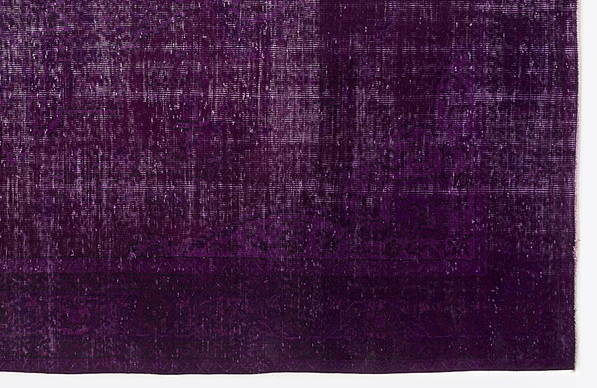 Deep purple vintage-style rug with a distressed, faded traditional medallion pattern.