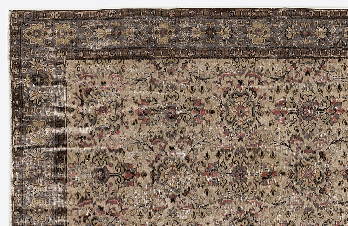 Beige and brown traditional rug with a distressed floral medallion pattern and a wide, ornate border.