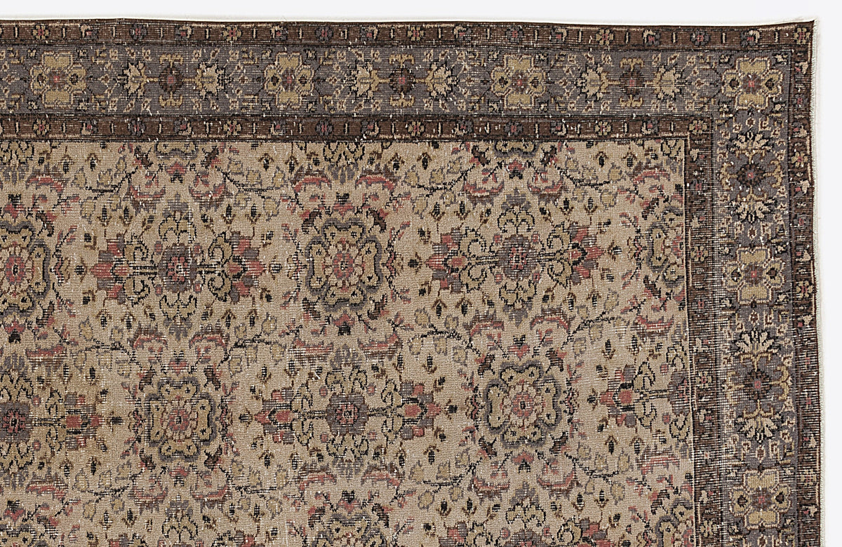 Beige traditional rug with a dark brown border and a repeating floral medallion pattern in muted red, grey, and black.