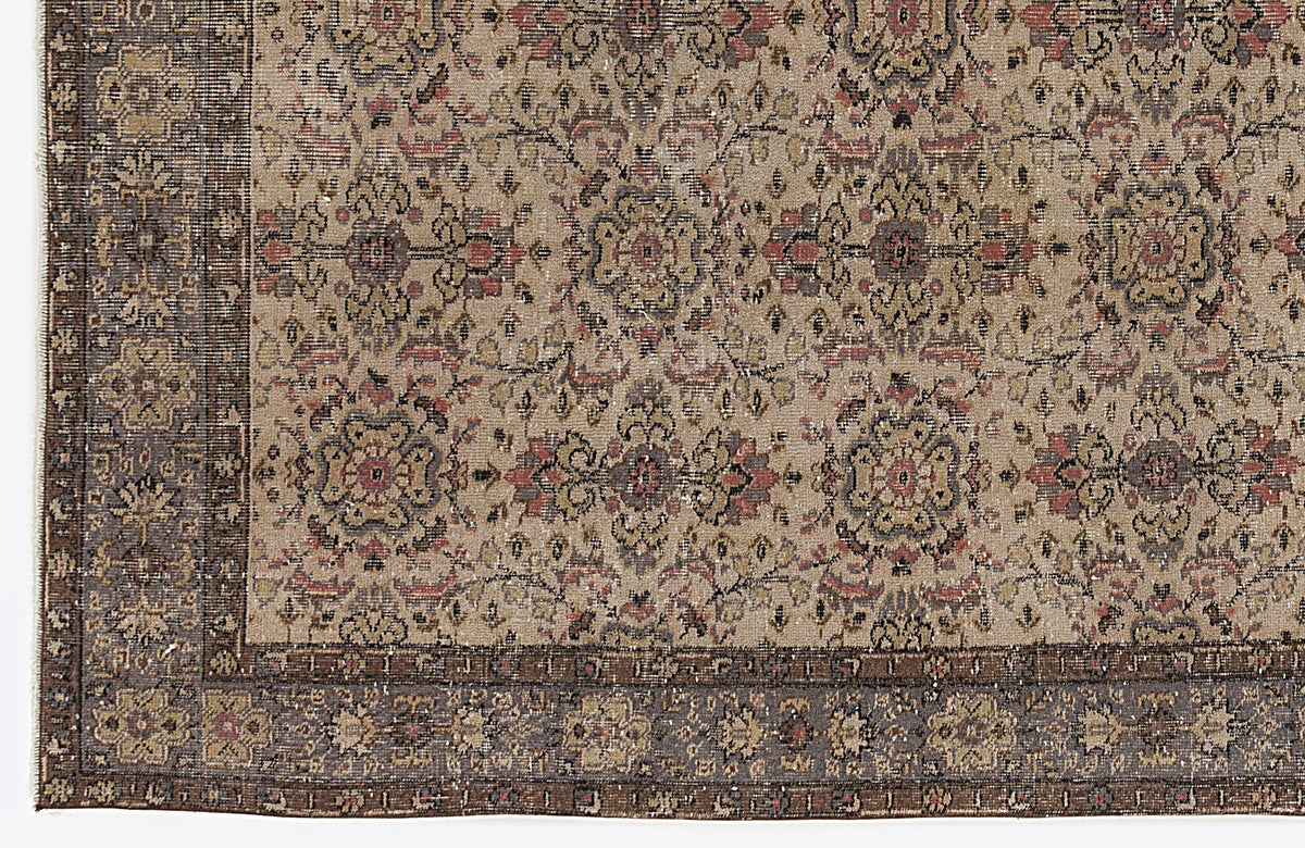 Beige and brown traditional rug with a distressed floral medallion pattern and a dark decorative border.
