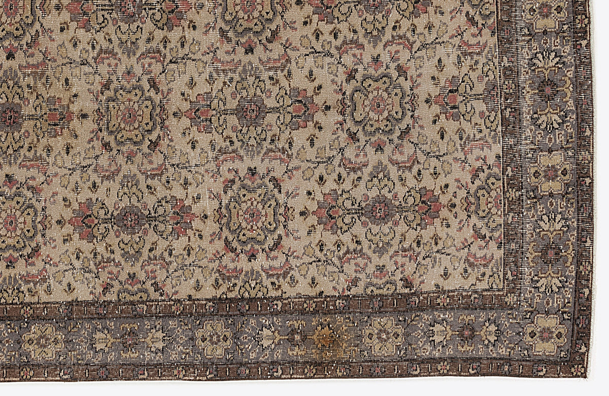 Beige, grey, and muted red traditional rug with a distressed floral medallion pattern and a dark decorative border.