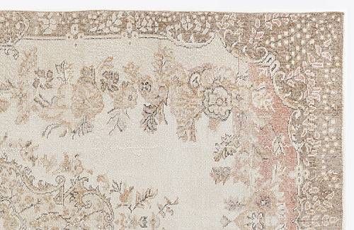 Load image 1 in gallery view. Beige and brown vintage-style rug with a faded floral medallion pattern and a distressed border.