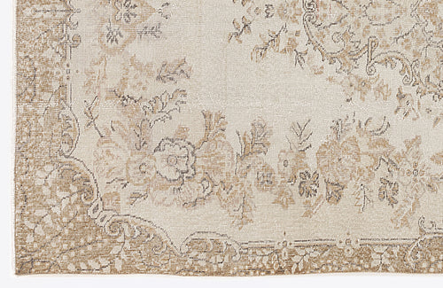 Load image 1 in gallery view. Beige and cream rug with a distressed traditional floral medallion pattern.