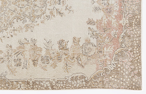 Load image 1 in gallery view. Cream, beige, and muted pink rug with a distressed traditional floral medallion pattern.