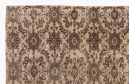 Load image 1 in gallery view. Beige and brown vintage-style rug with a repeating floral medallion pattern and distressed texture.
