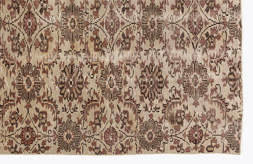 Load image 1 in gallery view. Beige and brown vintage-style rug with a repeating floral medallion pattern and distressed texture.