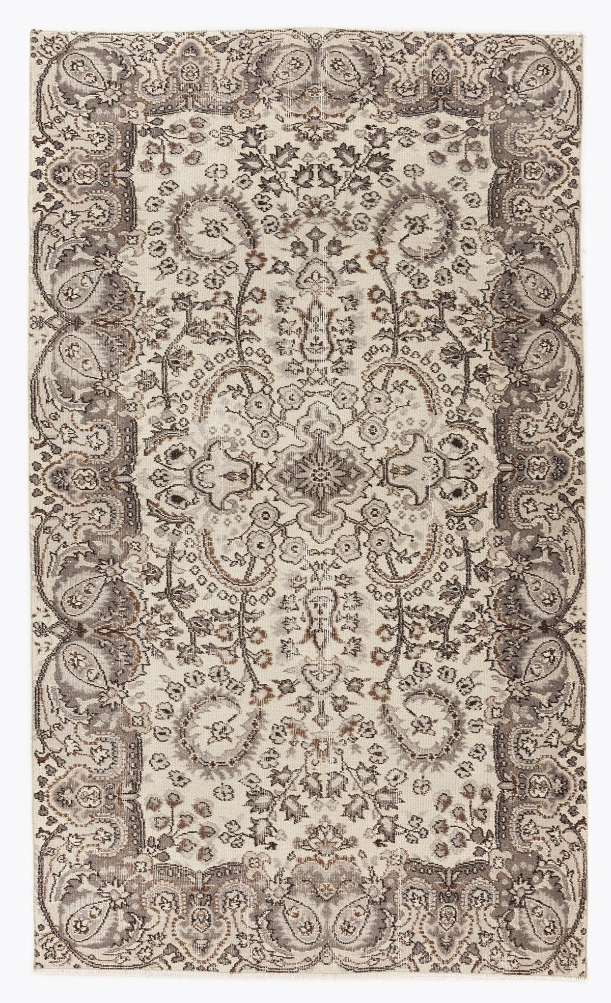 Cream and grey traditional rug with a distressed floral medallion pattern and ornate border.