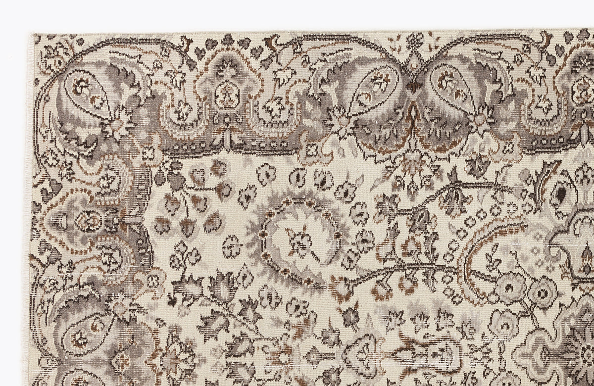 Cream, taupe, and brown traditional rug with an intricate paisley and floral medallion pattern.