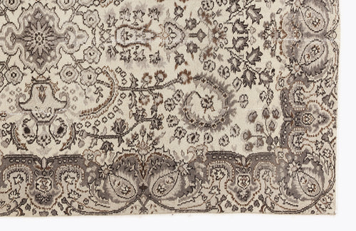 Load image 1 in gallery view. Cream, grey, and brown traditional rug with a distressed, intricate floral medallion and paisley pattern.