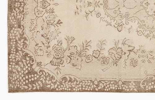 Load image 1 in gallery view. Beige and brown rug with a distressed floral medallion pattern and a detailed botanical border.
