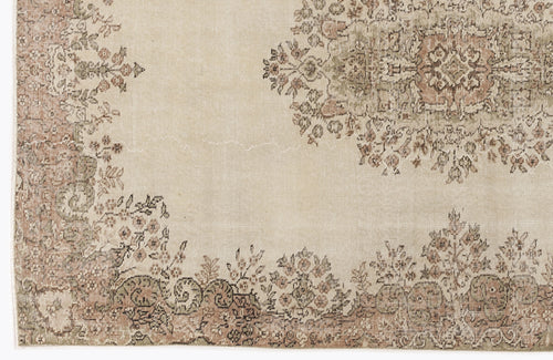 Load image 1 in gallery view. Beige rug with a faded floral medallion and border in muted terracotta and sage green.