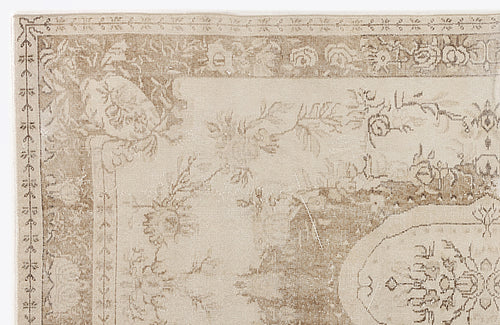 Load image 1 in gallery view. Beige and cream traditional rug with a distressed floral medallion pattern and ornate border.