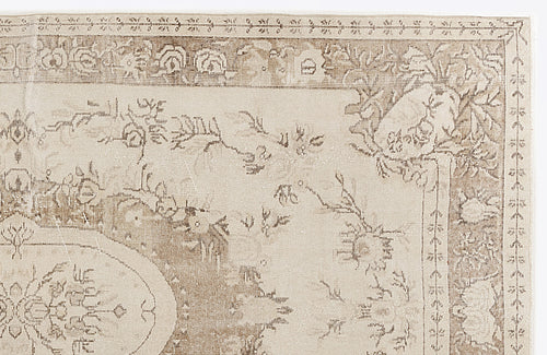 Load image 1 in gallery view. Beige and taupe traditional rug with a distressed floral medallion pattern and ornate border.