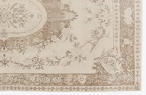Load image 1 in gallery view. Beige and taupe area rug with a distressed traditional floral medallion pattern and a decorative border.
