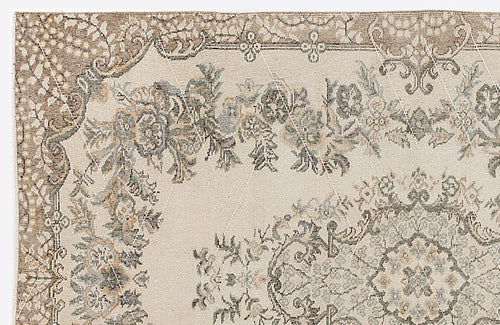 Load image 1 in gallery view. Beige and cream traditional rug with a distressed floral medallion pattern and muted blue and brown accents.