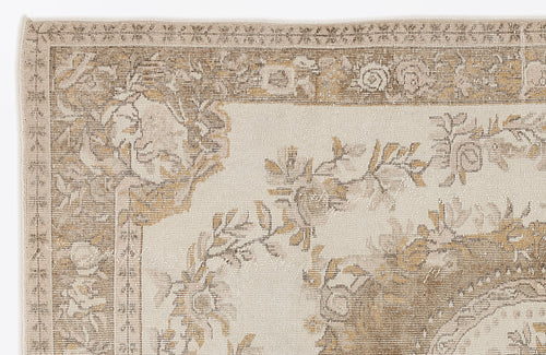 Load image 1 in gallery view. Beige and tan rug with a traditional floral medallion border and vine pattern on a cream field.