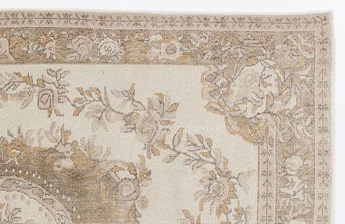 Load image 1 in gallery view. Cream and beige rug with a traditional floral medallion pattern and a decorative border on a white background.