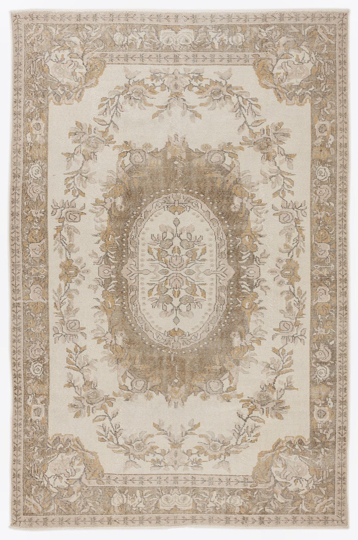 Beige and taupe traditional rug with a central floral medallion and ornate border on a white background.