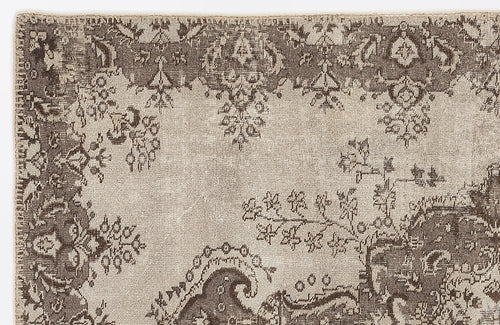 Load image 1 in gallery view. Taupe and beige traditional rug with a distressed, faded floral medallion pattern.