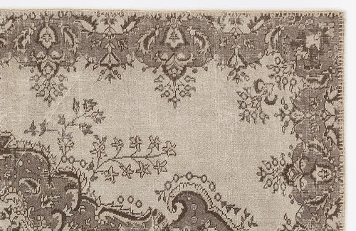 Load image 1 in gallery view. Taupe and beige rug with a distressed traditional floral medallion pattern on a white background.