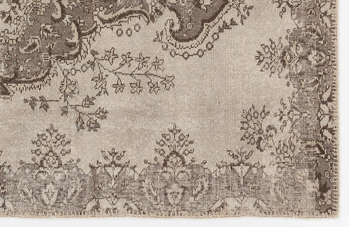 Load image 1 in gallery view. Taupe and dark brown rug with a distressed traditional floral medallion pattern on a white background.
