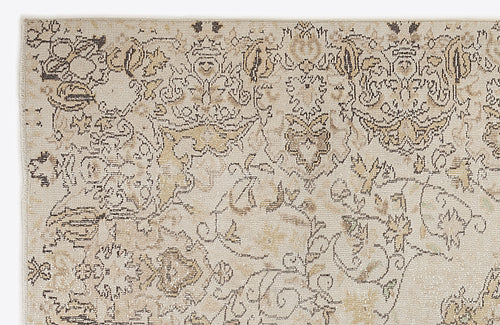 Load image 1 in gallery view. Beige and taupe traditional rug with a distressed, intricate floral medallion pattern on a white background.