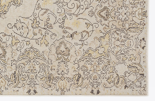 Load image 1 in gallery view. Beige and cream area rug with a distressed, traditional floral medallion pattern in charcoal and muted gold.