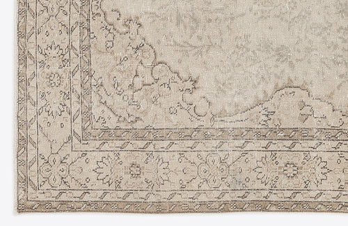 Load image 1 in gallery view. Beige and taupe rug with a distressed traditional floral medallion pattern and a geometric border.