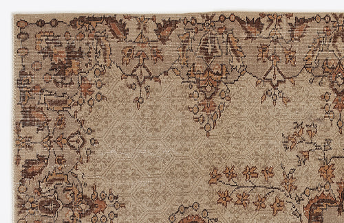 Load image 1 in gallery view. Tan and brown vintage-style rug with a distressed floral medallion border and a textured, neutral field.