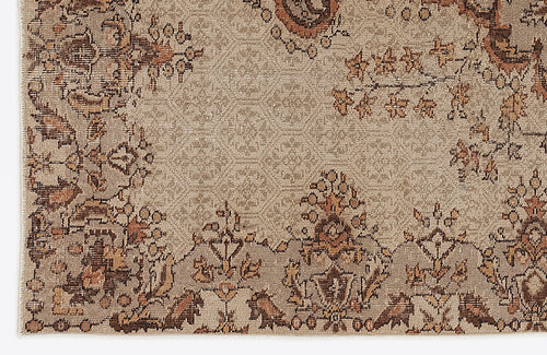 Load image 1 in gallery view. Tan and brown traditional rug with a distressed floral medallion pattern on a white background.