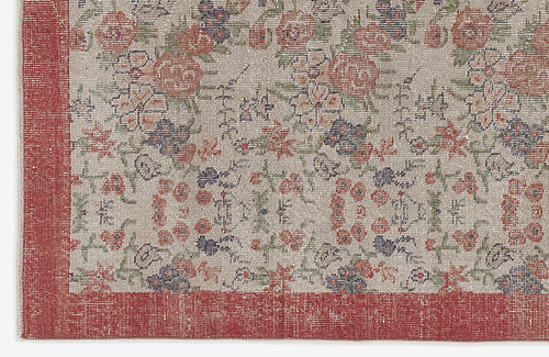 Load image 1 in gallery view. Beige rug with a distressed floral pattern in red, green, and dark blue, featuring a solid red border.