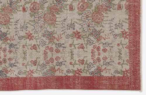 Load image 1 in gallery view. Beige rug with a distressed floral pattern in red, green, and blue, featuring a solid red border.