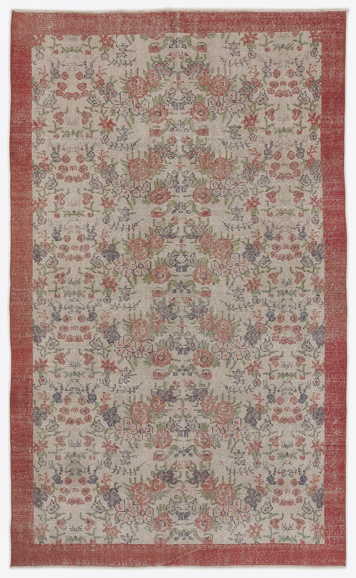 Beige rug with a red border and a repeating floral pattern in muted red, green, and blue tones.