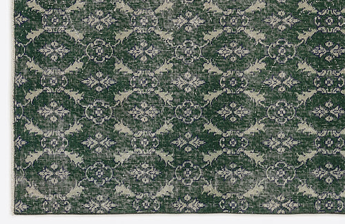 Load image 1 in gallery view. Dark green rug with a repeating light grey floral medallion pattern and a distressed, vintage-style finish.